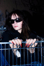 Model in sunglasses photographed at night wearing beoopsie press-on nails