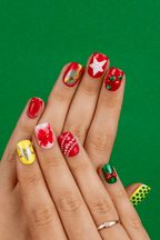 Carols and Cranberries Christmas press-on nails with stars and berries on green