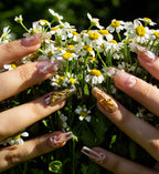 Gold coffin press-on nails on hand showing shimmer finish