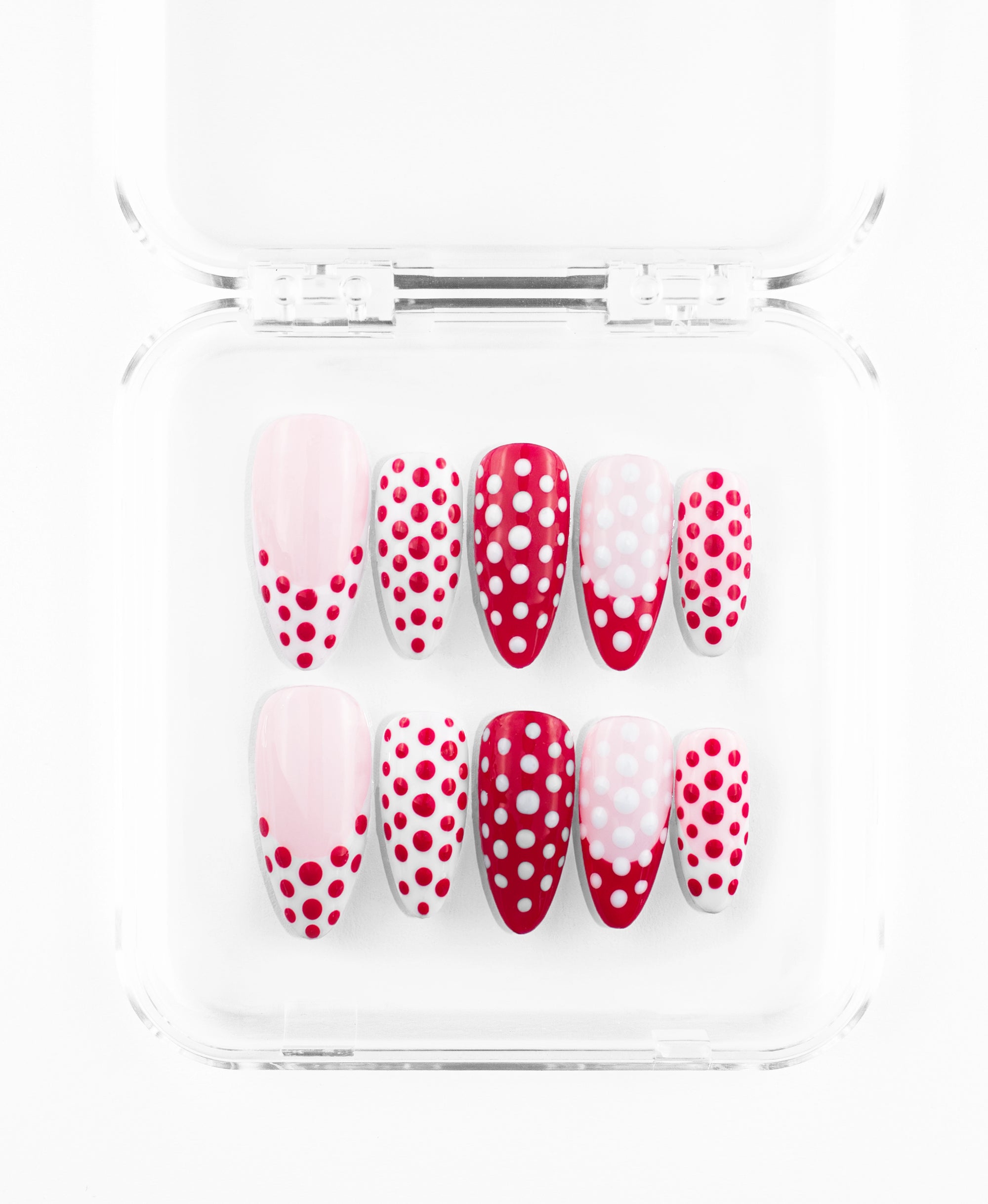 This polka-dot press-on set features a bold, graphic aesthetic on sleek almond-shaped nails in a palette of cherry red, crisp white, and soft pink. The collection centers on a striking variety of dot patterns, from layered 3D "bubble" dots on a deep red base to intricate white-on-red and red-on-white designs. With its mix of full-coverage patterns and modern dotted French tips, this set offers a fun, tactile, and high-contrast look that reinvents a classic print.