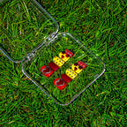Chrome Hearts press-on nail set in its clear case, lying in grass