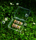 Golden Hour coffin press-on nails displayed in storage case on green background