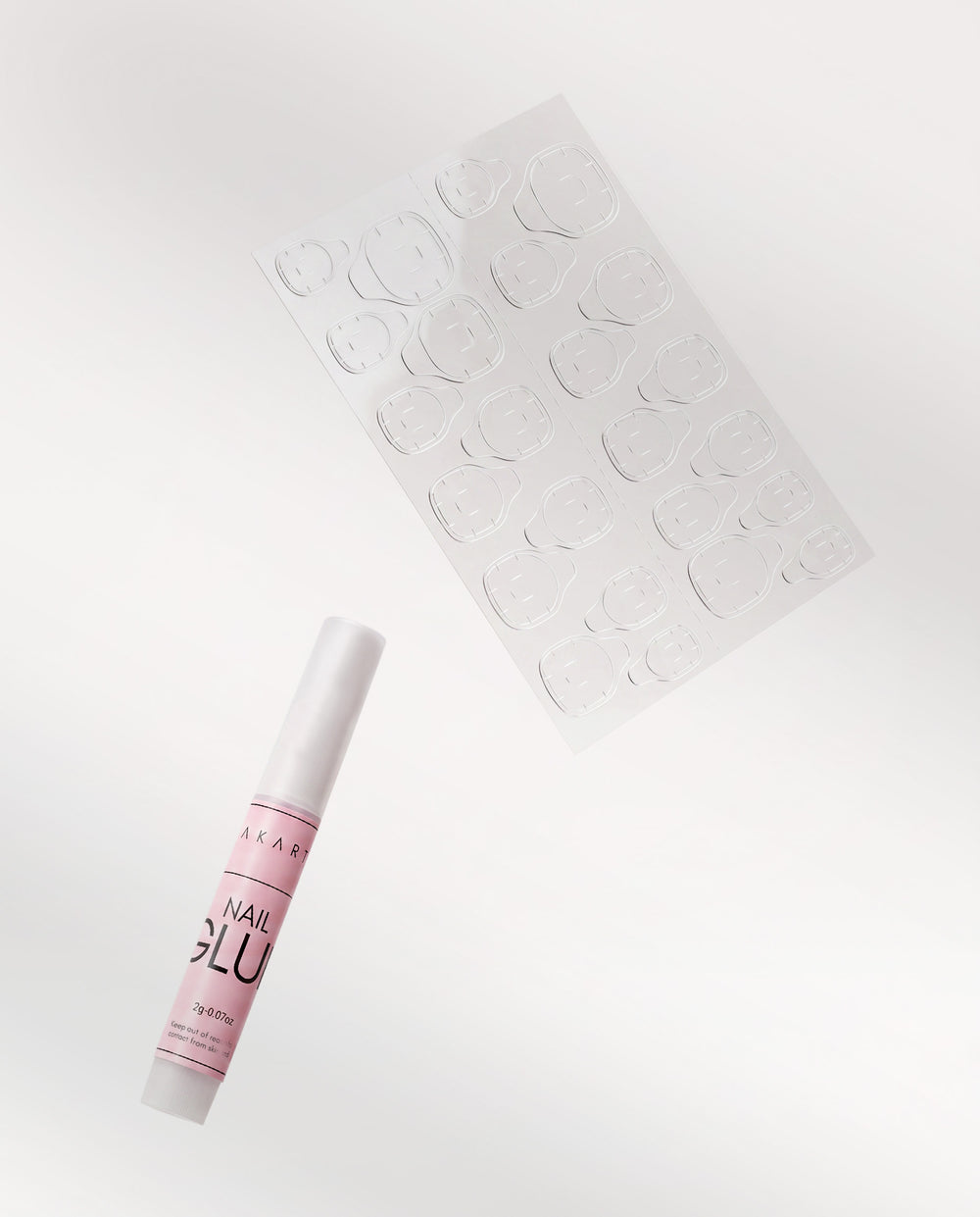 Sheet of adhesive sticky tabs and a beoopsie nail glue pen